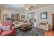 Spacious living room featuring hardwood floors, plush seating, and an open design concept at 3452 Village Park Sw Ln, Atlanta, GA 30331