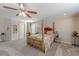 Spacious bedroom with a four-poster bed, ceiling fan, carpet floors and neutral walls at 3452 Village Park Sw Ln, Atlanta, GA 30331