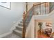 Traditional staircase with carpeted treads and dark wrought iron balusters at 3452 Village Park Sw Ln, Atlanta, GA 30331