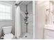 Well-lit bathroom featuring a tile shower, modern fixtures, and a window for natural light at 4293 Rickenbacker Ne Way, Atlanta, GA 30342