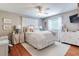 Bright bedroom features wood floors, a ceiling fan, and a large window for natural light at 4293 Rickenbacker Ne Way, Atlanta, GA 30342