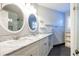 Bathroom with double sinks, marble countertops, and a glass-enclosed shower at 1346 Stillwood Chase Ne, Atlanta, GA 30306