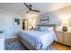 Cozy bedroom with a wooden bed frame, ceiling fan, and colorful rug at 1346 Stillwood Chase Ne, Atlanta, GA 30306