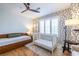 Bedroom featuring a crib, daybed, accent wall, and ample natural light at 1346 Stillwood Chase Ne, Atlanta, GA 30306