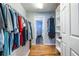 Walk-in closet with built-in shelving and clothing racks, with bath in background at 1346 Stillwood Chase Ne, Atlanta, GA 30306