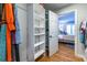 Organized closet with shelving units and clothes, open to Primary bedroom at 1346 Stillwood Chase Ne, Atlanta, GA 30306