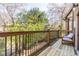 A peaceful view of backyard greenery from an upper deck, including a comfortable outdoor chair at 1346 Stillwood Chase Ne, Atlanta, GA 30306