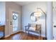 Cozy entryway featuring hardwood floors, a charming bench, and a stylish mirror and lamp at 1346 Stillwood Chase Ne, Atlanta, GA 30306