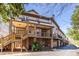 Charming townhome exterior featuring a porch, wood stairs, and a brick foundation with beautiful landscaping at 1346 Stillwood Chase Ne, Atlanta, GA 30306