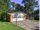 Brick home featuring a one-car garage and a well-maintained front yard at 3341 Rae Pl, Lawrenceville, GA 30044