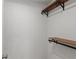 Bright closet space features two wooden shelves with black metal brackets and room for storage at 3655 Habersham Ne Rd # 215, Atlanta, GA 30305