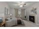Cozy main bedroom featuring a ceiling fan, fireplace, and natural light at 3655 Habersham Ne Rd # 215, Atlanta, GA 30305