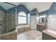 Bathroom features a soaking tub beneath an arched window, a glass enclosed shower and dual vanity sinks at 4118 Kentmere Main Nw, Kennesaw, GA 30144