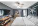 A cozy bedroom featuring dark gray walls, a mounted TV, and a comfortable bed with stylish bedding at 4118 Kentmere Main Nw, Kennesaw, GA 30144