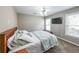 Bedroom with a queen-sized bed, carpeted floor, and two windows for natural light at 4118 Kentmere Main Nw, Kennesaw, GA 30144