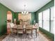 Elegant dining room with modern chandelier, bright windows, and decorative green walls at 4118 Kentmere Main Nw, Kennesaw, GA 30144