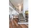 Inviting foyer with hardwood floors, a staircase, and views into other living spaces at 4118 Kentmere Main Nw, Kennesaw, GA 30144