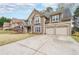 Attractive two-story home with a stone facade, a well-manicured lawn, and a two-car garage at 4118 Kentmere Main Nw, Kennesaw, GA 30144