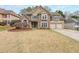 Charming two-story home with stone accents, a well-maintained lawn, and a two-car garage at 4118 Kentmere Main Nw, Kennesaw, GA 30144
