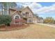 Charming two-story home with stone accents, a well-maintained lawn, and a two-car garage at 4118 Kentmere Main Nw, Kennesaw, GA 30144