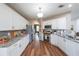 Well-lit kitchen features stainless steel appliances, granite counters, and updated cabinets at 4118 Kentmere Main Nw, Kennesaw, GA 30144