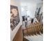 Bright foyer showcasing a high ceiling, wooden staircase with metal railings, and large floral artwork at 4118 Kentmere Main Nw, Kennesaw, GA 30144