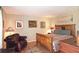Comfortable bedroom with wood bed frame and sitting area at 47 Monet Nw Ct, Atlanta, GA 30327