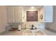 Bright kitchen featuring decorative wall art and dual basin sink at 47 Monet Nw Ct, Atlanta, GA 30327
