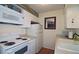 Well-lit kitchen features white appliances and white cabinetry at 47 Monet Nw Ct, Atlanta, GA 30327