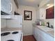 Functional kitchen features white appliances, and white cabinetry at 47 Monet Nw Ct, Atlanta, GA 30327