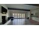 Spacious living room featuring hardwood floors, white walls, and a walkout to a pool at 47 Monet Nw Ct, Atlanta, GA 30327