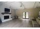 Spacious living room features a brick fireplace, modern lighting, and French doors to bring the outside in at 47 Monet Nw Ct, Atlanta, GA 30327
