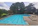 A sparkling swimming pool with lane markers and lounge chairs offers a great place for exercise and fun at 47 Monet Nw Ct, Atlanta, GA 30327