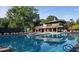 A refreshing pool with lounge chairs and umbrellas provides the perfect spot for relaxation and recreation at 47 Monet Nw Ct, Atlanta, GA 30327