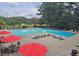 Enjoy a relaxing day by the pool with ample seating, umbrellas, and clear, cool water at 47 Monet Nw Ct, Atlanta, GA 30327