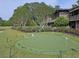 A pristine putting green is surrounded by manicured landscaping and is perfect for improving your golf skills at 47 Monet Nw Ct, Atlanta, GA 30327