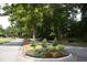 Landscaped neighborhood street with decorative flower beds at 47 Monet Nw Ct, Atlanta, GA 30327