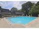 Outdoor community pool with plenty of seating for residents in a green space at 47 Monet Nw Ct, Atlanta, GA 30327