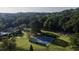 Aerial view of blue and green tennis courts surrounded by green trees at 47 Monet Nw Ct, Atlanta, GA 30327