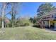 View of the lush backyard, with mature trees, from the deck offering a serene and private outdoor space at 1450 Pinyon Pl, Lawrenceville, GA 30043