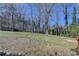 Expansive backyard view showcasing the grassy area and mature trees surrounding the property, providing ample space at 1450 Pinyon Pl, Lawrenceville, GA 30043