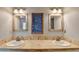 The main bathroom has a double sink vanity, tile floors, and and mirrors at 1450 Pinyon Pl, Lawrenceville, GA 30043