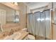 Bathroom with tiled shower and countertops, and white sink at 1450 Pinyon Pl, Lawrenceville, GA 30043