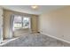 Bedroom with neutral walls, carpeted floor, and a large window providing natural light at 1450 Pinyon Pl, Lawrenceville, GA 30043