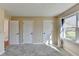 Bedroom with natural light from window with three white doors and neutral carpet at 1450 Pinyon Pl, Lawrenceville, GA 30043