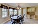 The kitchen eating area has lots of windows for natural light, an adjacent built-in desk and a door to the outside at 1450 Pinyon Pl, Lawrenceville, GA 30043