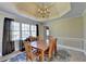Dining room features wood table with six chairs, and windows at 1450 Pinyon Pl, Lawrenceville, GA 30043