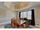 Dining area with trey ceiling, chandelier, and windows providing natural light at 1450 Pinyon Pl, Lawrenceville, GA 30043