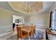 Classic dining room featuring a chandelier, table with six chairs, and a window with curtains at 1450 Pinyon Pl, Lawrenceville, GA 30043