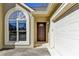 Close-up of front door, arched window, and attached two-car garage at 1450 Pinyon Pl, Lawrenceville, GA 30043